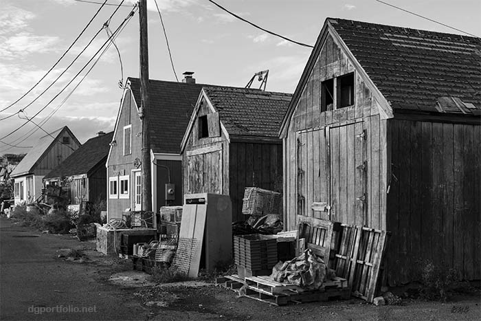 Black and white image of wooden fishing shacks in Rockport, MA.
